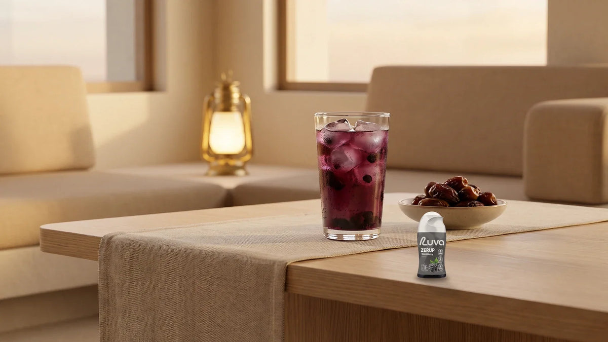 ZERUP by LUVA Blackberry bottle with a glass of berry drink and a bowl of dates in a majlis-style living room