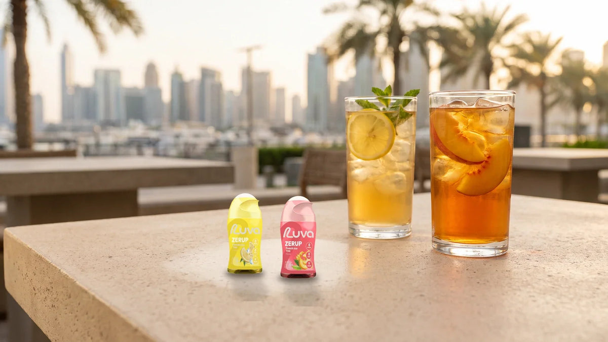 ZERUP by LUVA Lemon Iced Tea and Peach Iced Tea bottles with two glasses of iced tea on a Dubai terrace