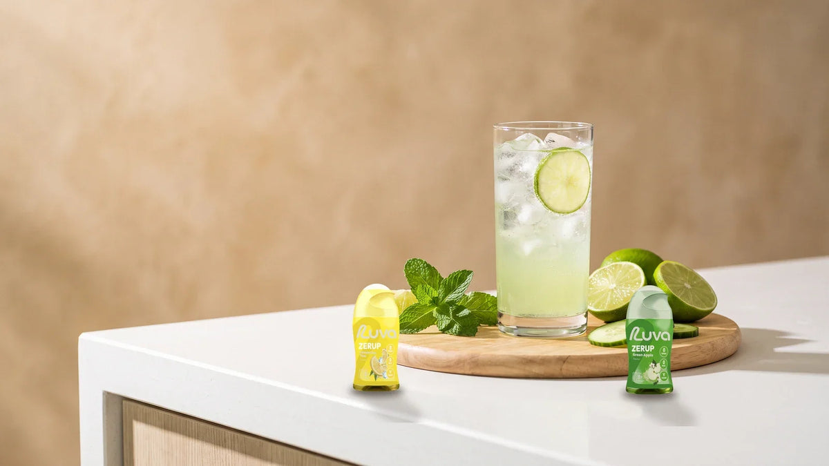 ZERUP by LUVA Lemon Iced Tea and Green Apple bottles with fresh lime, mint and a glass of sparkling water